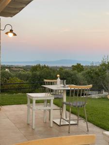 a table and two chairs and a table and a table and chair at Sunshine House in Skala Fourkas