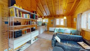 ein Wohnzimmer mit einem Sofa und einer Küche in der Unterkunft Ferienhaus Rehbock RB0 in Blatten bei Naters