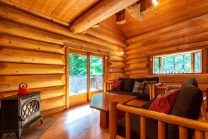 Una sala de estar con chimenea en una cabaña de troncos en Suite Villa Hakone Sengokuhara Canadian Log, en Hakone 27 fotos más