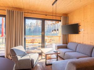 a living room with a couch and a tv at Gorgeous Chalet in Steinach am Brenner near Ski Area in Steinach am Brenner