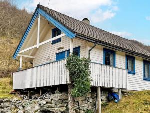 una casa con techo azul en una colina en Three-Bedroom Holiday home in Åkra en Kyrping