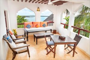 a living room with a couch and a table and chairs at Royal House Shela in Lamu