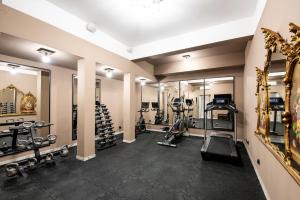 a gym with tread machines and mirrors in a room at Villa Vis a Vis in Trzęsacz