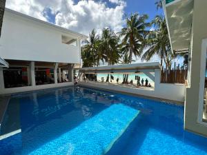 a swimming pool with a view of the beach at Calypso Beach and Dive Resort in Boracay