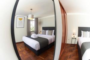 a bedroom with a bed and a mirror at Lovely 3bedroom apt infront Sta Catalina Monastery in Arequipa