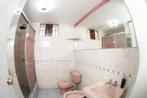 a bathroom with a pink toilet and a sink at Lovely 3bedroom apt infront Sta Catalina Monastery in Arequipa