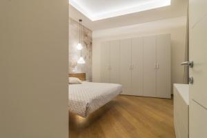 Postel nebo postele na pokoji v ubytování Tuscus Apartments