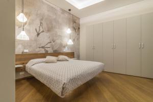 Postel nebo postele na pokoji v ubytování Tuscus Apartments