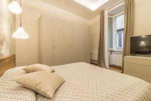 Postel nebo postele na pokoji v ubytování Tuscus Apartments