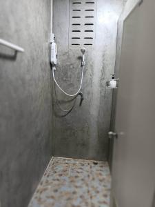 eine Duschkabine mit einem Schlauch im Bad in der Unterkunft ชิดชล โฮมสเตย์ แอทอัมพวา in Bang Khon Thi