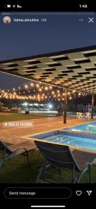 a picture of a swimming pool at night at Alreef farm in Ras al Khaimah
