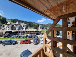 a view of a parking lot with cars parked at Apartman Vučko 118 in Jahorina