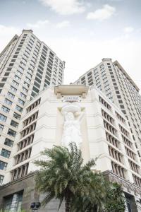 a building with a statue in front of two tall buildings at D'LEROI SOLEIL- TAY HO- NEAR WESTLAKE IN HA Noi in Hanoi