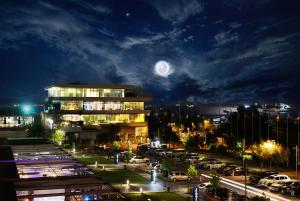 a view of a city at night with a full moon at Ataköy Marina Park Hotel Residence in Istanbul