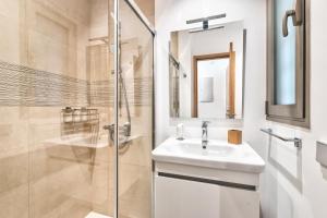 a white bathroom with a sink and a shower at Jardines - Tabor 0-2 POOL VIEW & GARDEN 1B in Palm-mar +10 photos