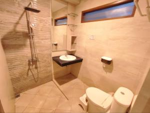 a bathroom with a toilet and a sink at Papringan Suite House in Demangan +19 photos