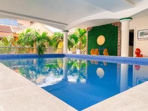 a swimming pool in a house with palm trees at Thanh Lich Hue Hotel in Hue