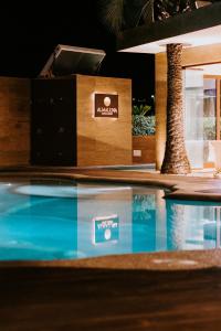a table with two boxes and a pool at Almaluna Hotel & Resort in Alba Adriatica