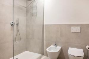 a bathroom with a shower and a toilet and a sink at Eichhof Apartment Lavendel in Termeno +24 photos