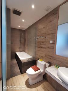 a bathroom with a toilet and a sink and a tub at Kyoto Boutique Hotel in Johor Bahru