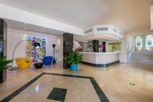 a large room with a lobby with a counter at Hotel La Santa Maria in Cala Millor