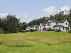 a house on a hill with a green field at Millerbeck in Ambleside
