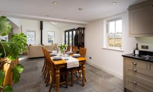 a kitchen and dining room with a table and chairs at Beck View in Troutbeck