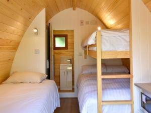 a bedroom with two bunk beds in a small room at Riverside Mill Glamping Pod in Grayrigg