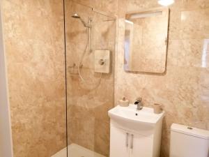 a bathroom with a shower and a toilet and a sink at Riverside View in Nairn