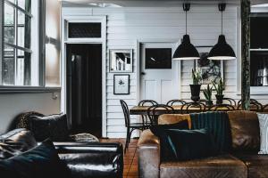 a living room with couches and a table and chairs at The Station House Daylesford in Daylesford