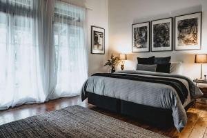 a bedroom with a large bed and a window at The Station House Daylesford in Daylesford