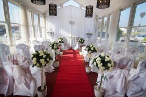 a room with white chairs and a red carpet at Westport Country Lodge Hotel in Westport