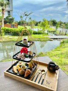a tray with a plate of food on a table at Kenting Sand Island W-Villa Seaview Resort in Fan-tzu-liao