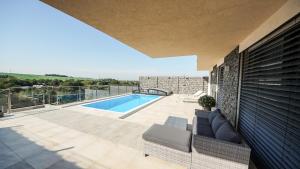 a house with a swimming pool on a patio at Elite House in Moravany nad Váhom