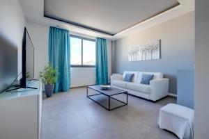 a living room with a couch and a tv at Perfect Location Idyllic 2BR Apartment in Sliema