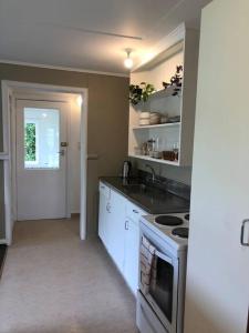 a kitchen with a sink and a stove top oven at Comfy at Ed's - 20 mins to Kaiteri & Abel Tasman in Motueka