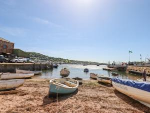 a group of boats on the shore of a body of water at Shipwrights Cottage in Teignmouth