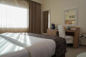 Posteľ alebo postele v izbe v ubytovaní Toledo Amman Hotel