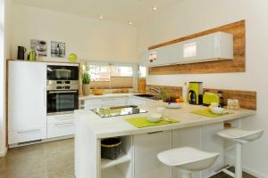 a kitchen with white cabinets and a white counter top at Straße der Freundschaft 30c in Ostseebad Karlshagen