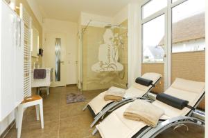 a hospital room with two chairs and a shower at Straße der Freundschaft 30c in Ostseebad Karlshagen +16 photos