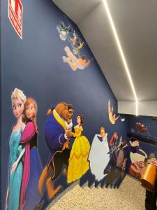 a room with a disney mural on the wall at Hotel Paula Films Collection in Mérida