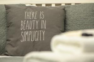 a pillow that says there is beauty in simplicity at Pass the Keys Apartment next to Lincoln Castle in Lincoln