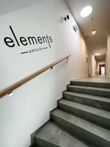 a set of stairs with a sign on the wall at Penzión Elements in Trnava