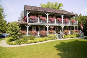 a house with flower boxes on the balcony at WeatherPine Inn in Niagara-on-the-Lake