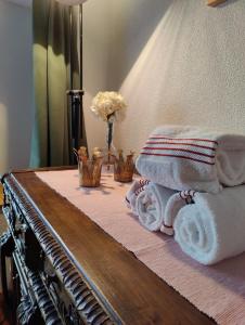 a table with towels and flowers on top of it at Hubel Apartment 14 in Wilderswil