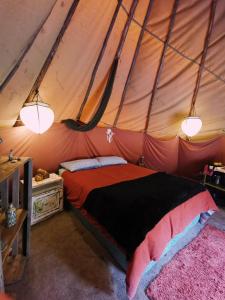 a bedroom with a bed in a tent at Forest Harmony in Knysna