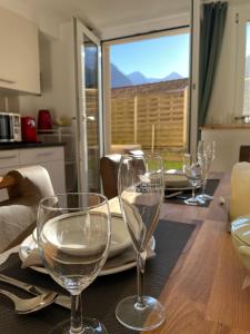 uma mesa de jantar com copos de vinho em Hubel Apartment 14 em Wilderswil