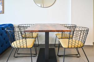 a dining table with chairs around it in a room at Life`s A Beach by HolyGuest in Tel Aviv