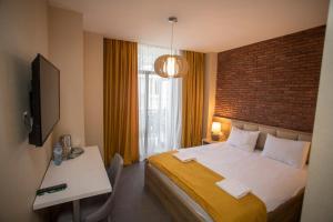 Postel nebo postele na pokoji v ubytování Hotel London