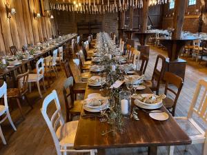 a long wooden table in a large room with chairs at Hotel Schloss Diepenbrock in Bocholt